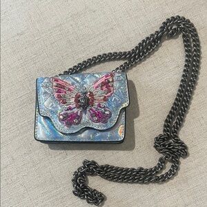 Kurt Geiger Iridescent Blue Crossbody with Pink Crystal Butterfly